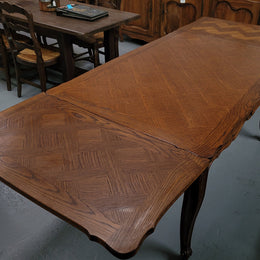 French Oak Louis XV style parquetry top extension table. It can sit six people when not extended and eight when fully extended. It has been sourced from France and is in original detailed condition.