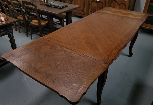 French Oak Louis XV style parquetry top extension table. It can sit six people when not extended and eight when fully extended. It has been sourced from France and is in original detailed condition.