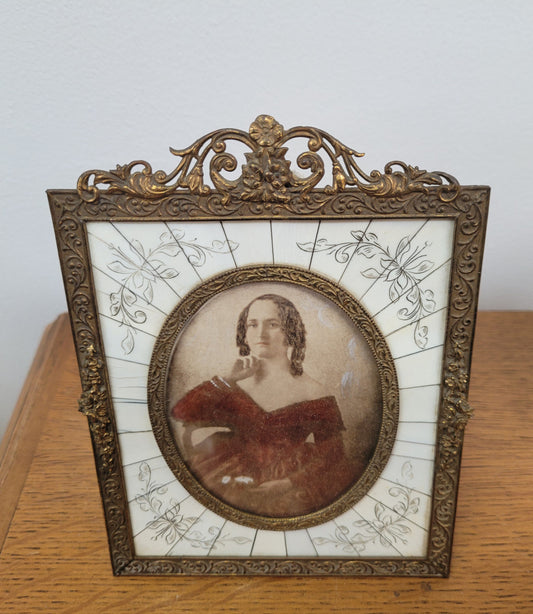 Hand coloured early photo of women in a stunning frame with paino key surround and detailed gilded metal frame.