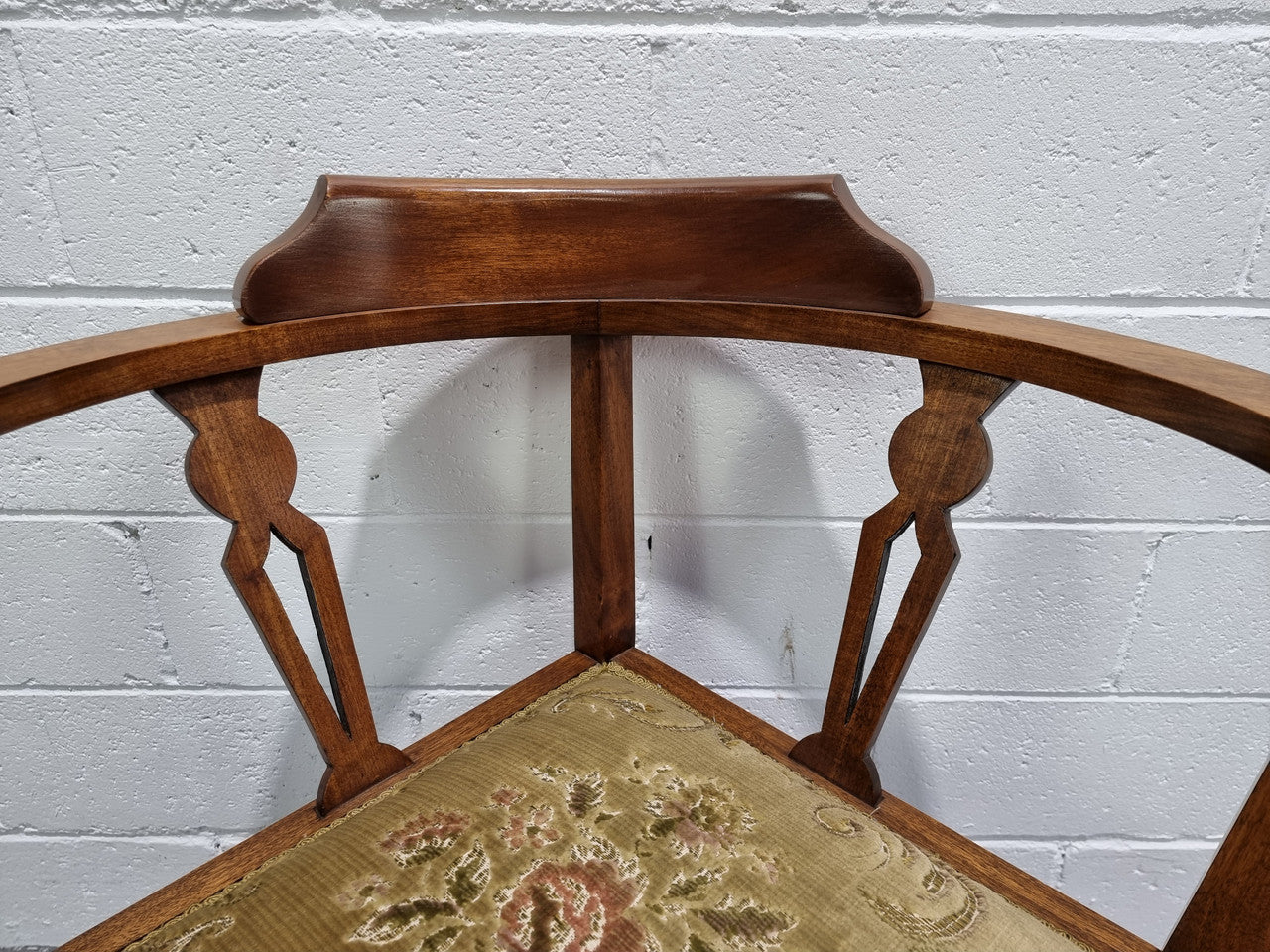 Mahogany upsholstered corner chair. It is in good original condition with clean upholstery.