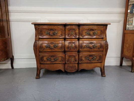 French Antique Louis XIV style Oak wooden top commode. It has a stunning serpentine bombe shape front along with amazing handles and carvings. It comes with three beautiful keys as pictured and comes with working locks. It has been sourced from France and in good original detailed condition.