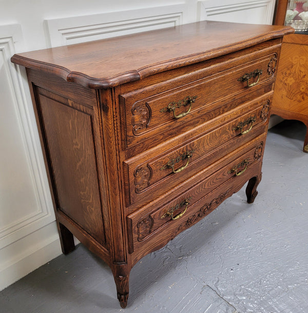 French Louis XV style Oak three drawer chest with wooden top. It has been sourced from France and is in good original detailed condition.