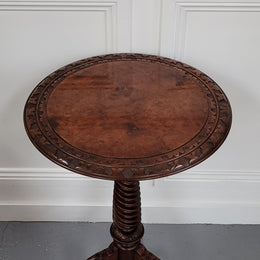 Rare early Victorian Irish Burr Walnut wine table. It has a beautiful carvings and a stunning burr walnut top, on a barley twist column and three shaped legs. It has been sourced locally and is in good original detailed condition. We also have a second table being sold separately which when together make a matched pair.