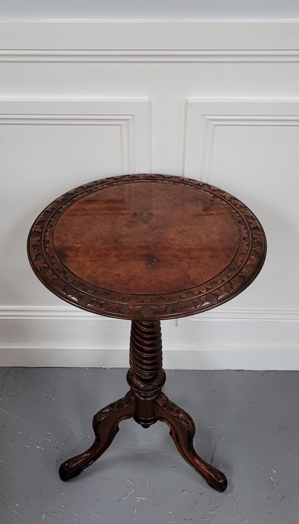 Rare early Victorian Irish Burr Walnut wine table. It has a beautiful carvings and a stunning burr walnut top, on a barley twist column and three shaped legs. It has been sourced locally and is in good original detailed condition. We also have a second table being sold separately which when together make a matched pair.