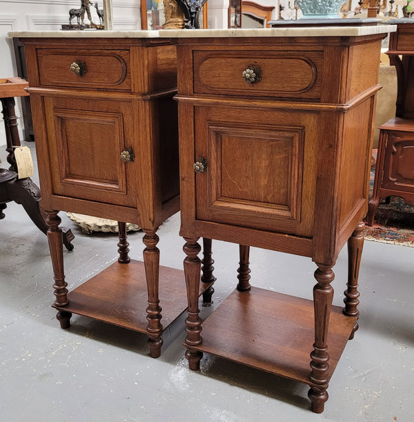 Antique French Oak Henry II white marble top bedside cabinets. They have one drawer and cupboard a long with an open shelf at the bottom. Sourced from France and in good original detailed condition.