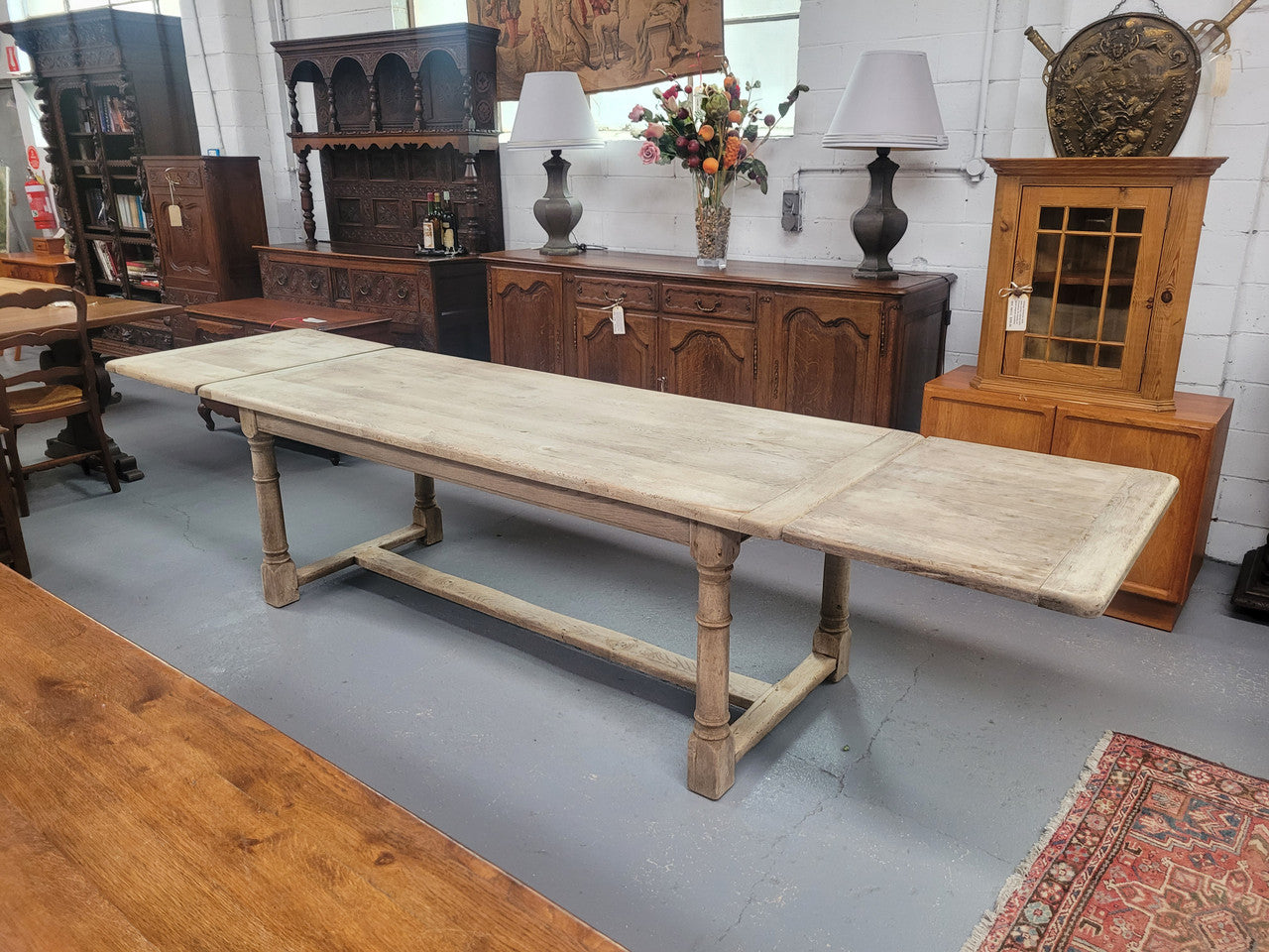 Beautilful raw solid oak French pedestal extension table. It has been sourced from France and is in good original detailed condition. When the table is fully extended it is 339 cm long and can comfortable seat 10-12 people. Features raw wood that could be used as is for a distressed look, or finished and waxed for a more refined look.