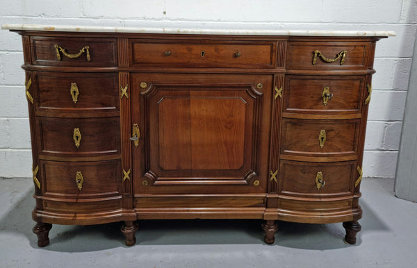 Fabulous French Walnut Louis XVI style cupboard, with a lovely marble top and nine drawers. There is also a cupboard and beautiful ormolu mounts. It is in good original detailed condition.