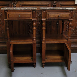Pair of French Antique Oak marble top bedsides Henry II style. They have a drawer, cupboard and an open shelf for all your storage needs. They have been sourced from France and are in good original detailed condition.