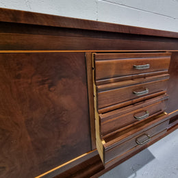 Amazing French Walnut Art deco four door buffet. The doors either side open to a fixed shelf and plenty of added storage with four drawers. In good original detailed condition.