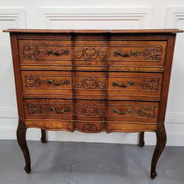 Vintage French dark Oak Louis XV style chest of three drawers. It has beautiful cabriole legs, elegant brass handles and decorative carving throughout. It is in good original detailed condition and has been sourced from France.
