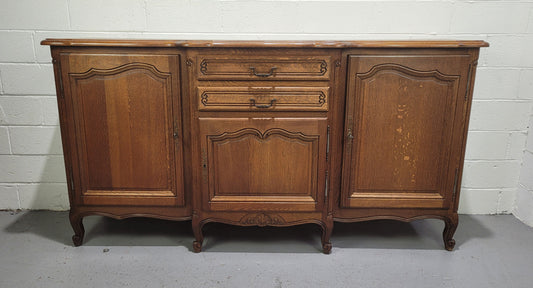 French Louis XV style parquetry top three door sideboard with two drawers. Plenty of storage space with a shelf behind each door. It is in good original detailed condition.