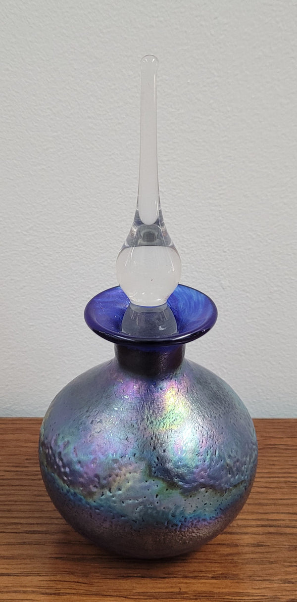 Stunning iridescent hand blown perfume bottle. Beautiful peacock blue, purple colours. Signed on base with clear glass stopper.