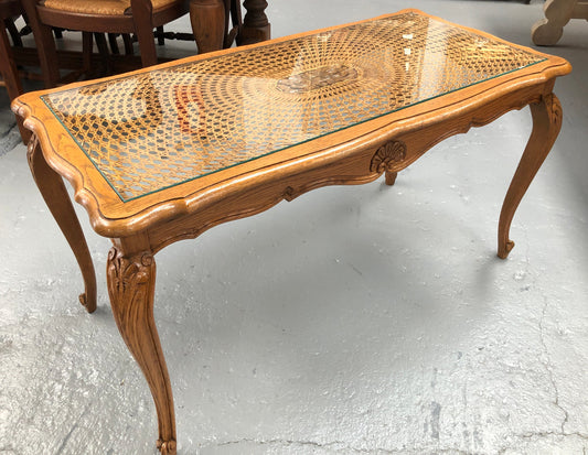 Lovely French Oak Louis XV style cane top coffee table with a glass top. In good original detailed condition.