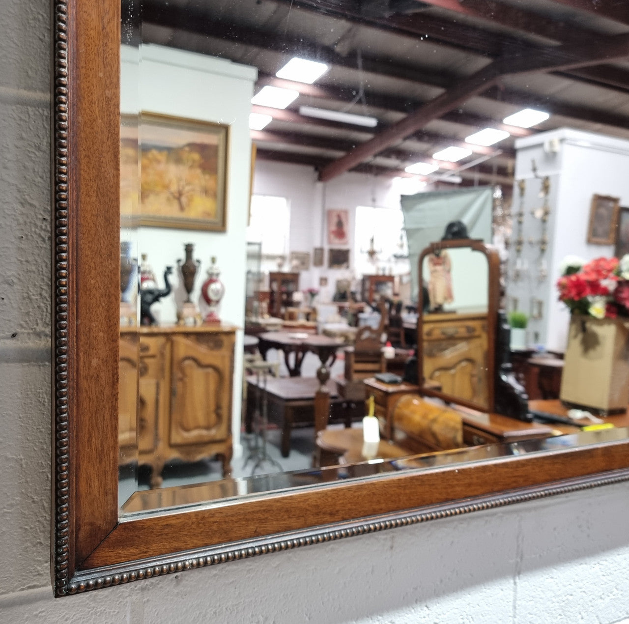 Attractive Edwardian rectangular wall mirror, with carved detail and beaded edge. Retaining it's original bevelled edge mirror and is in good original condition.