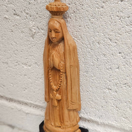 Vintage Olivewood statue of praying Virgin Mary on dark wooden plinth. Condition comensurate with age, please view photos as they help form part of the description.