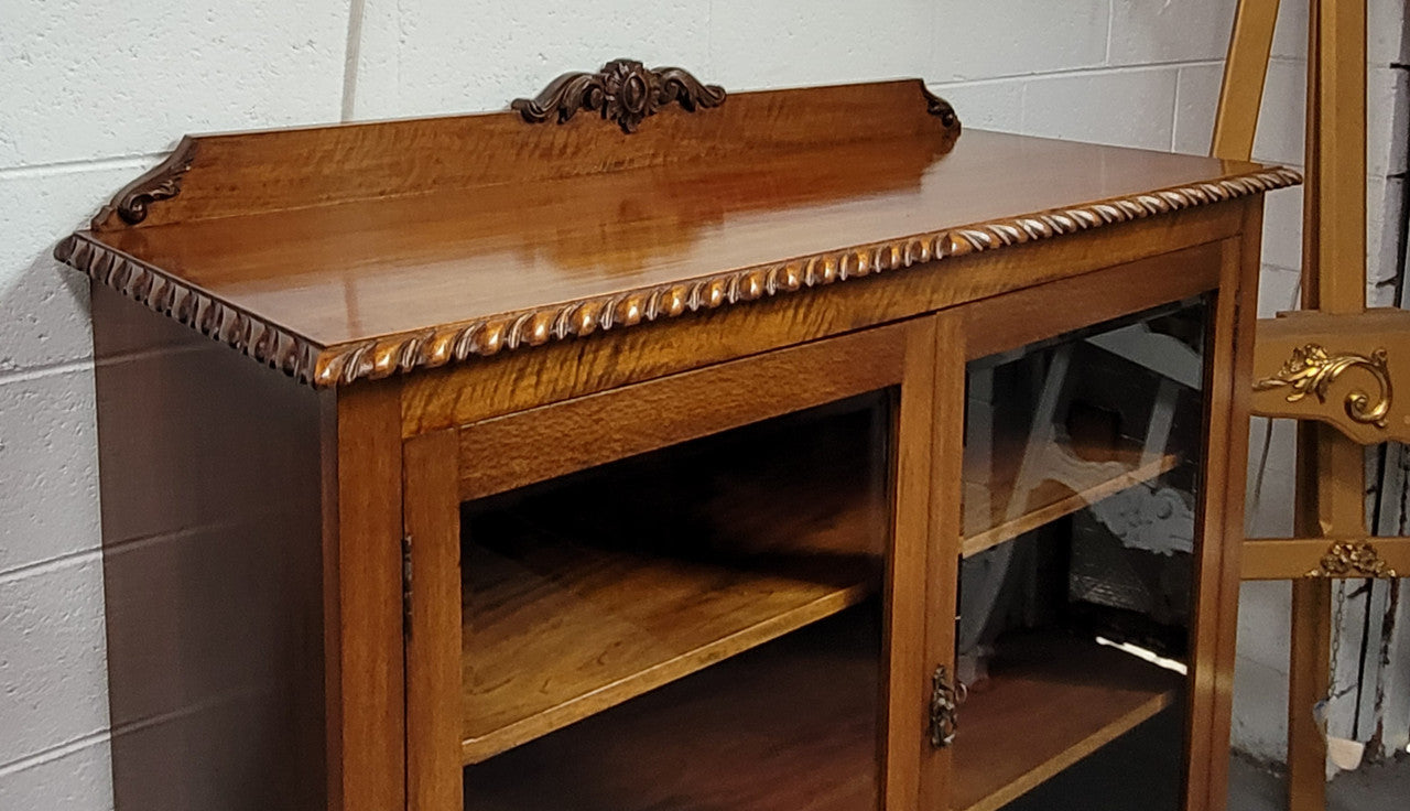Chippendale style Mahogany two door bookcase. It has bevelled glass doors and two adjustable shelves. It has been sourced locally and is in good original detailed condition.