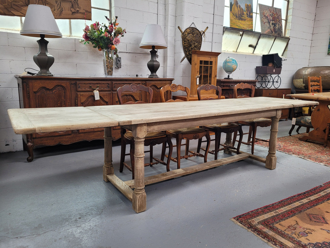 Beautilful raw solid oak French pedestal extension table. It has been sourced from France and is in good original detailed condition. When the table is fully extended it is 339 cm long and can comfortable seat 10-12 people. Features raw wood that could be used as is for a distressed look, or finished and waxed for a more refined look.