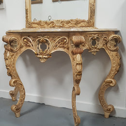 Beautifully carved Italian Rococo style painted console/hall table and mirror. An amazing coloured marble top showing sections of gold veins and is in good condition. Mantle mirror is retaining it's original mirror and showing ages spots.