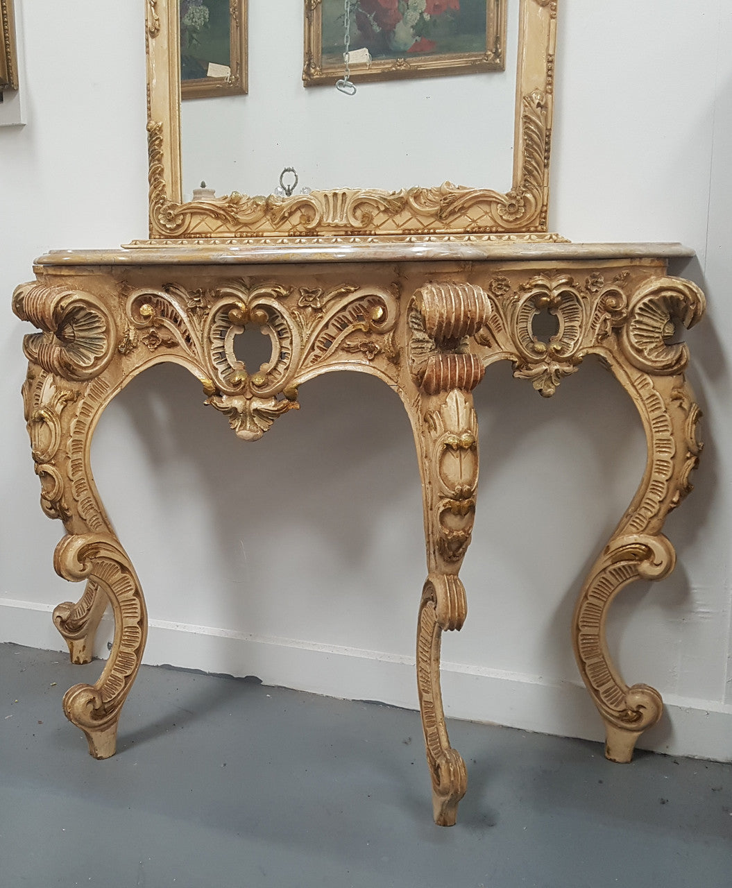 Beautifully carved Italian Rococo style painted console/hall table and mirror. An amazing coloured marble top showing sections of gold veins and is in good condition. Mantle mirror is retaining it's original mirror and showing ages spots.