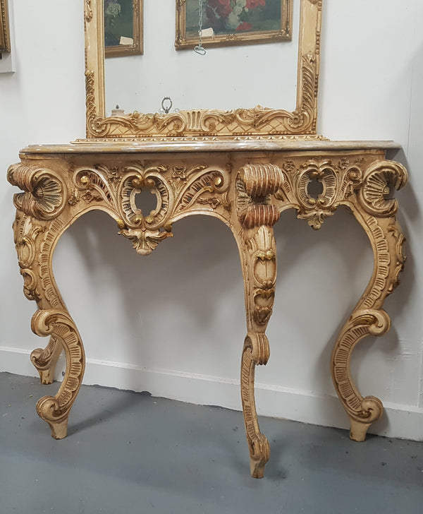 Beautifully carved Italian Rococo style painted console/hall table and mirror. An amazing coloured marble top showing sections of gold veins and is in good condition. Mantle mirror is retaining it's original mirror and showing ages spots.