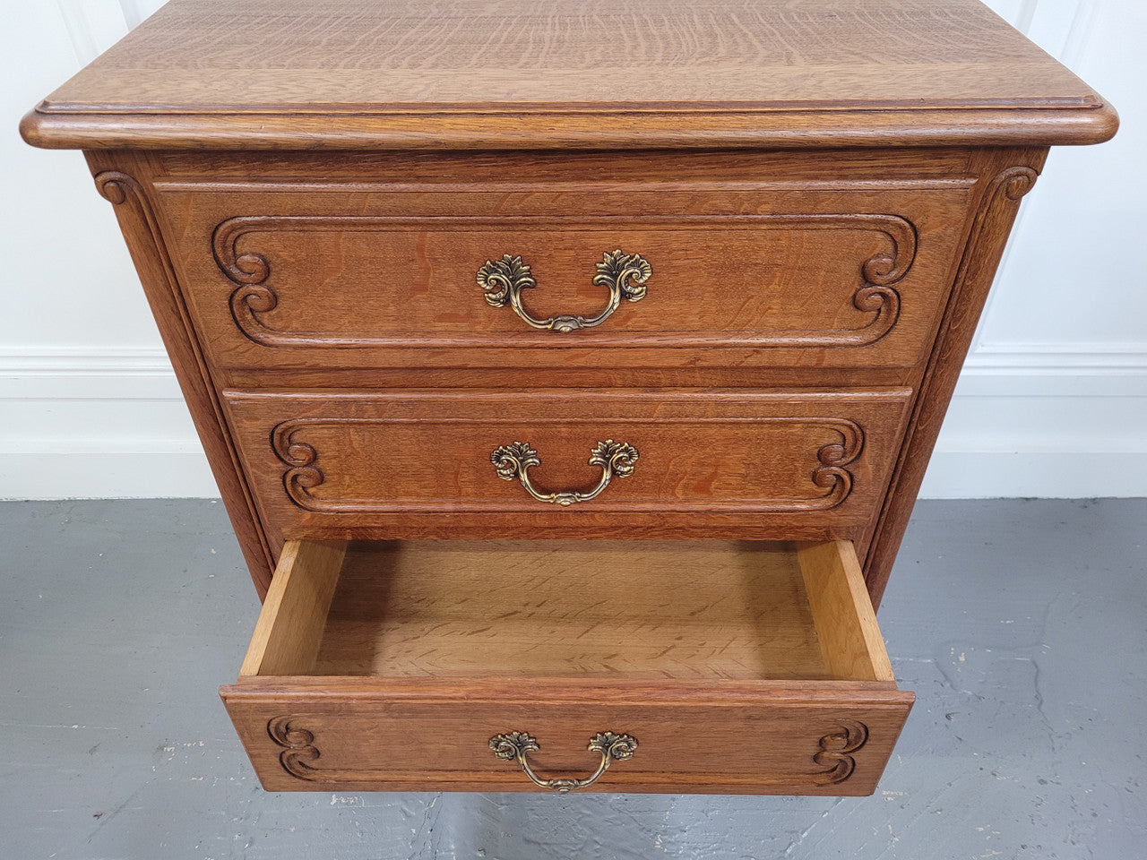 French Oak Louis XV style side drawers with lovely handles and three drawers. It has been sourced from France and is in good original detailed condition.