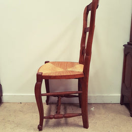 A set of six French Louis XV style, ladder back oak chairs. With finely carved detail and rush seat. In great original condition. Chairs are comfortable and sturdy for everyday use.