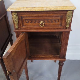 French Oak pair of Louis 16th style marble top bedsides with stunning bronze mounts. They have been sourced from France and are in good original detailed condition.