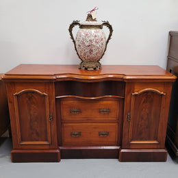 An English Victorian Mahogany sideboard with nine drawers. This amazing piece has loads of storage with three central drawers in the middle and a further six drawers. It has three each side located behind two doors. It has been sourced from locally and in original detailed condition.