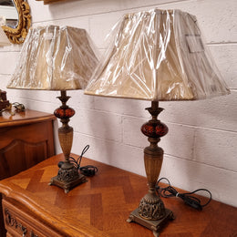 Beautiful pair of metal and glass lamp bases with new gold shades. They are in good original working condition and have been sourced locally.