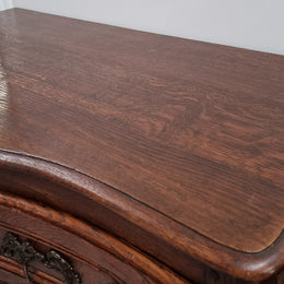 Antique French beautifully carved dark Oak commode with three drawers and ornate handles. It is in good original detailed condition.