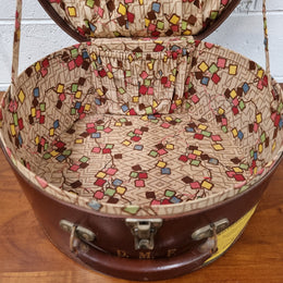 Charming solid leather hatbox with patterned fabric interior and two interior pockets. Interior stamp is for The Mutual Store Melbourne. Bears paper stamps for P&O Cruise Passenger” & “Peninsular  the top and D.M.F. in gold near the handle. Circa: Early 1900’s. 43 cm across and H:21 cm the lid.