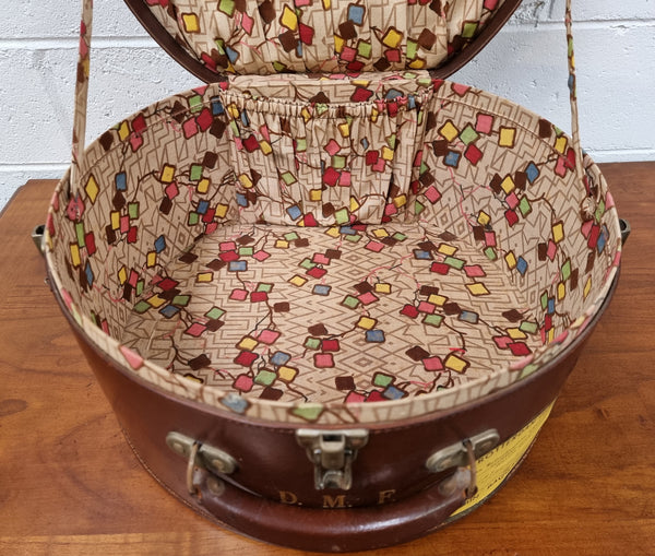 Charming solid leather hatbox with patterned fabric interior and two interior pockets. Interior stamp is for The Mutual Store Melbourne. Bears paper stamps for P&O Cruise Passenger” & “Peninsular  the top and D.M.F. in gold near the handle. Circa: Early 1900’s. 43 cm across and H:21 cm the lid.