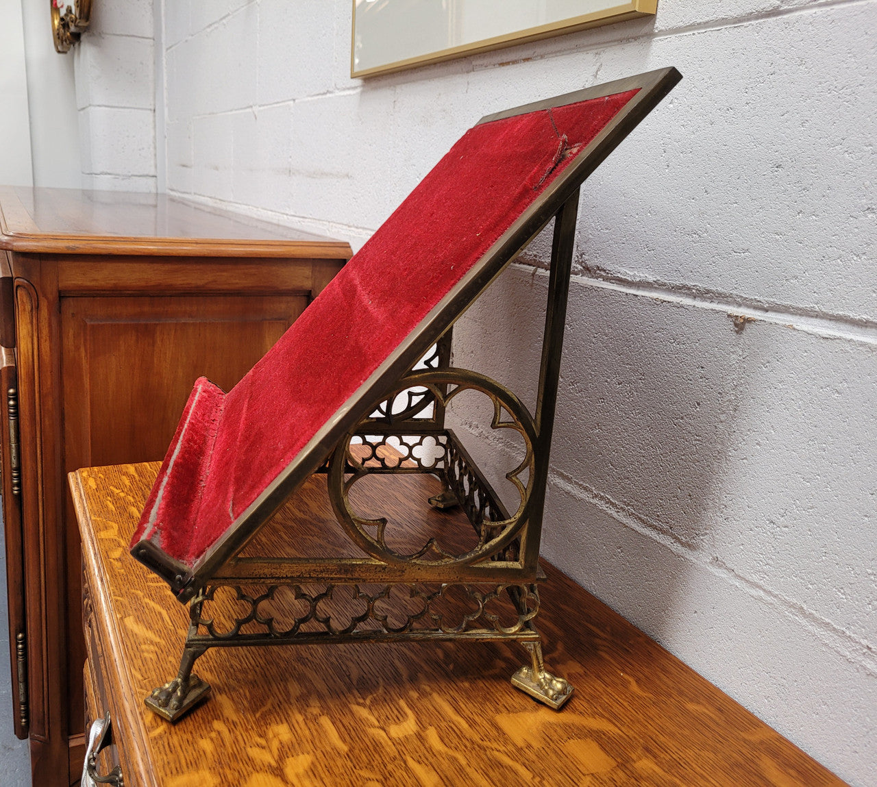 Antique French brass Gothic Revival book stand with red velvet. It has sourced from France and is in good original condition.