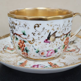 “Old Paris Porcelain” large cup and saucer, beautifully decorated with birds, grapes, floral sprays and heavily gilded. Dated to base 1835. In good original condition please view photos as they help form part of description.