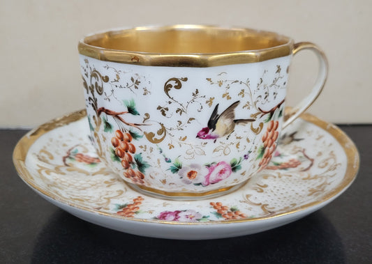 “Old Paris Porcelain” large cup and saucer, beautifully decorated with birds, grapes, floral sprays and heavily gilded. Dated to base 1835. In good original condition please view photos as they help form part of description.