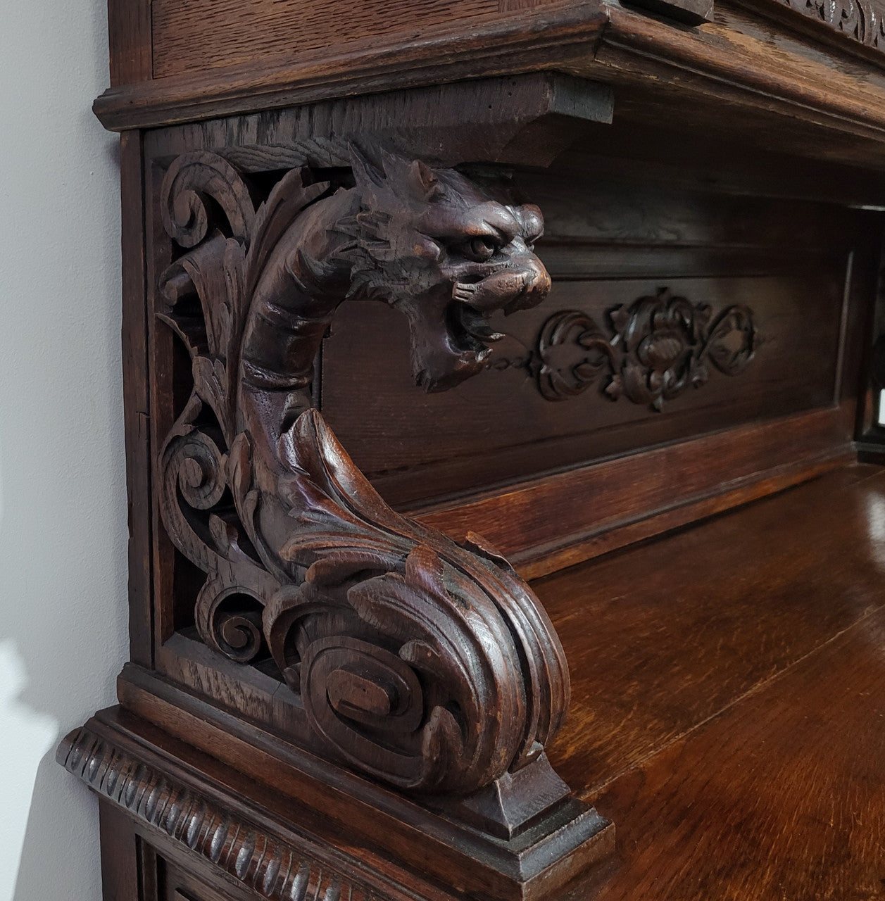 Grand French Oak Gothic style buffet with amazing detailed carvings. This stunning buffet has a display section at the top with two adjustable shelves, two drawers in the middle with elegantly carved handles and storage below with one fixed shelf. It is in good original detailed condition.