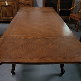 French Oak Louis XV style parquetry top extension table. It can sit six people when not extended and eight when fully extended. It has been sourced from France and is in original detailed condition.
