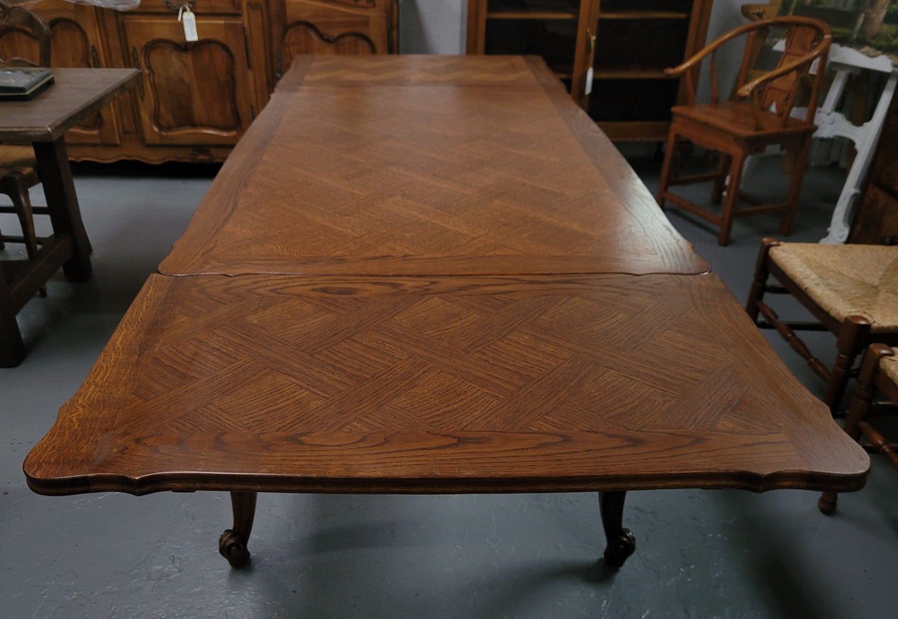 French Oak Louis XV style parquetry top extension table. It can sit six people when not extended and eight when fully extended. It has been sourced from France and is in original detailed condition.