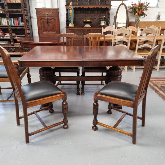 Tudor oak dining setting consisting of draw leaf extension table, 4 dining chairs and 2 carver chairs. Upholstery in excellent condition. Circa: 1930’s. The table, chair and carver chairs are in good original detailed condition.