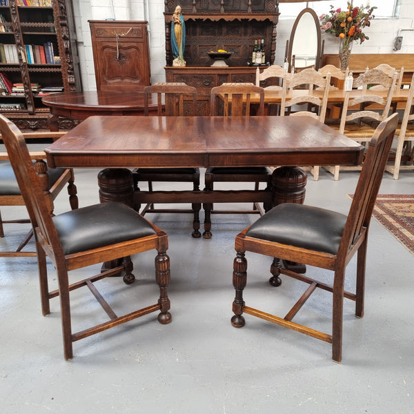 Tudor oak dining setting consisting of draw leaf extension table, 4 dining chairs and 2 carver chairs. Upholstery in excellent condition. Circa: 1930’s. The table, chair and carver chairs are in good original detailed condition.