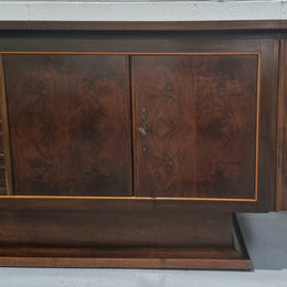 Amazing French Walnut Art deco four door buffet. The doors either side open to a fixed shelf and plenty of added storage with four drawers. In good original detailed condition.