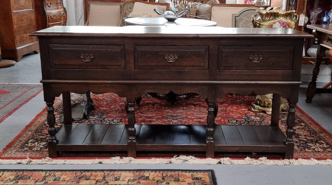 A very hard to find Vintage English kitchen dresser base of narrow proportions, sourced from France. In good original detailed condition.