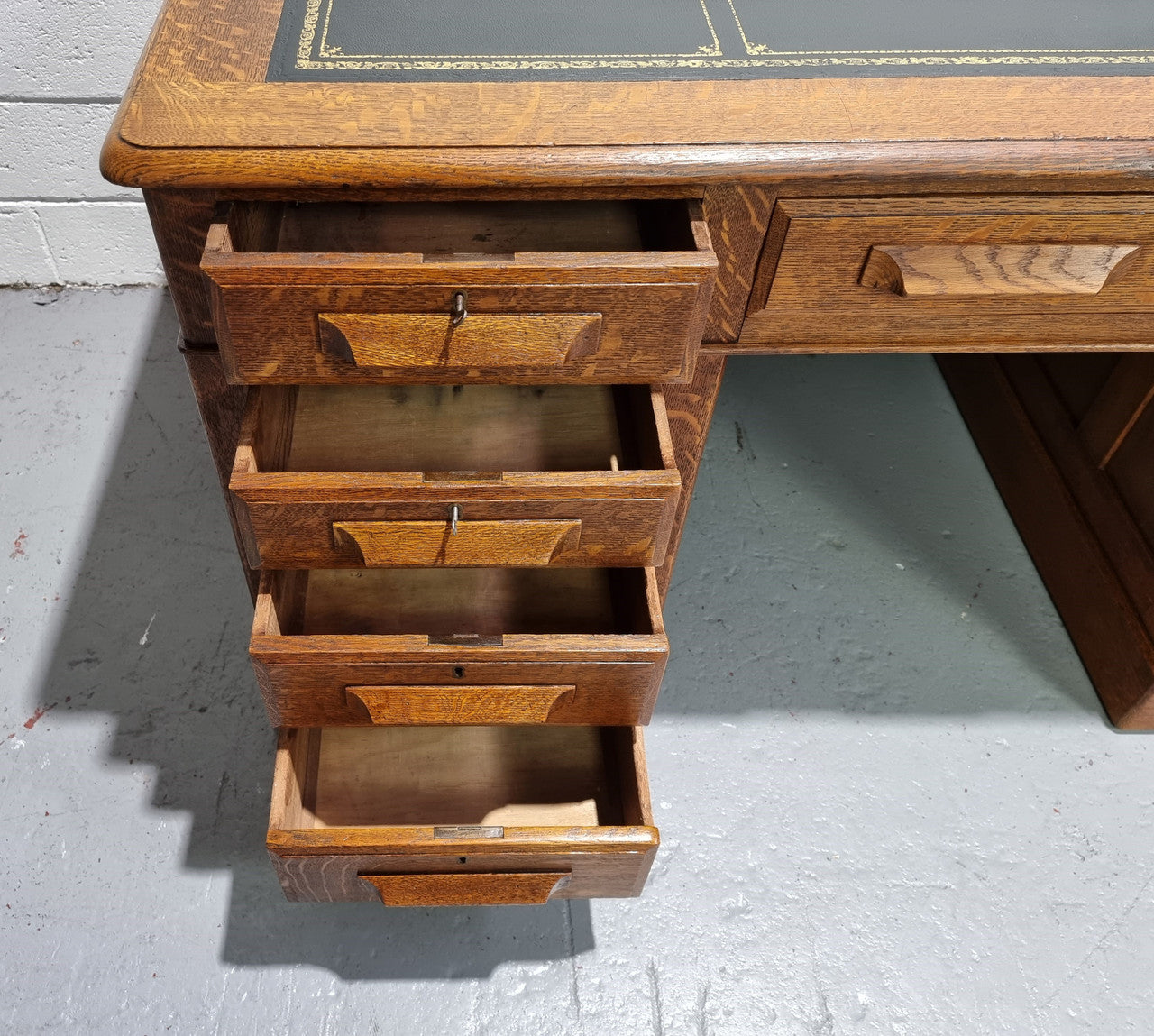 Amazing American Oak full partners leather top desk. Plenty of storage space with nine drawers on one side and two cupboards of the oppsite side. It is in good restored condition and has a new leather and gold tooled inset top.