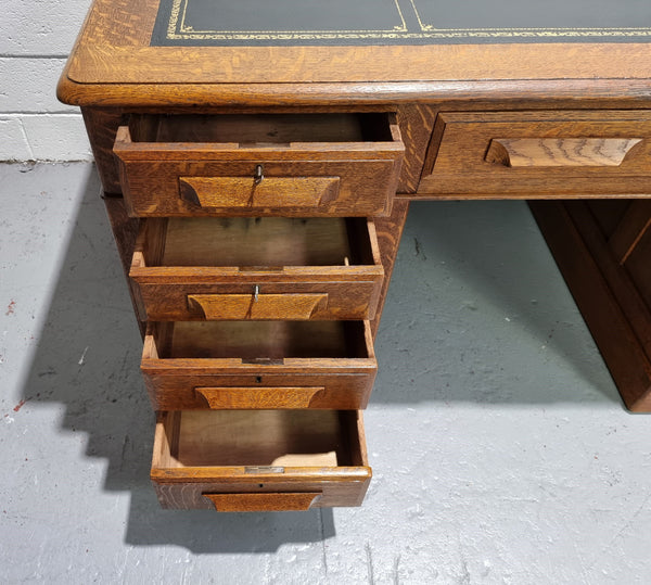 Amazing American Oak full partners leather top desk. Plenty of storage space with nine drawers on one side and two cupboards of the oppsite side. It is in good restored condition and has a new leather and gold tooled inset top.