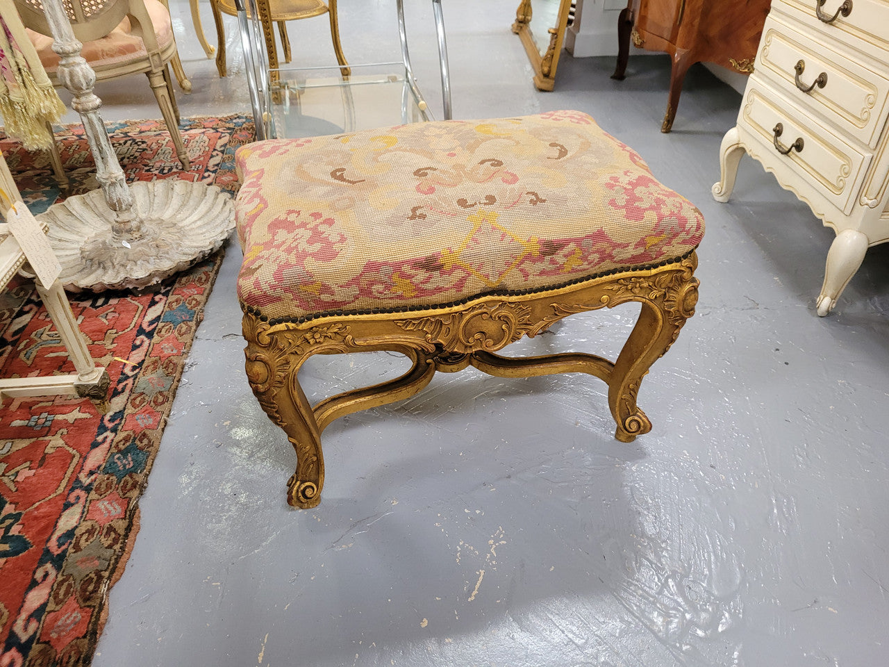 Charming 19th Century gilt wood tapestry covered Louis XV style stool. It has a beautifully carved base and undercarriage and it has been sourced from France. It is in good original detailed condition, please view photos of tapestry has they help form part of the description.