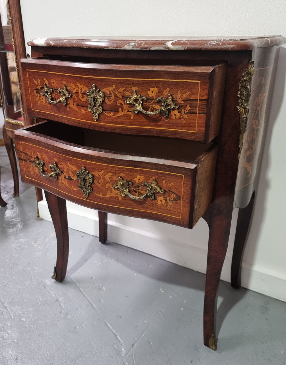 A stunning French petite two drawer inlaid Rosewood commode. In good original detailed condition.