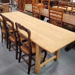 French raw Oak stretcher based refectory table. Features raw wood that could be used as is for a distressed look, or finished and waxed for a more refined look. Sourced from France and in good original condition.