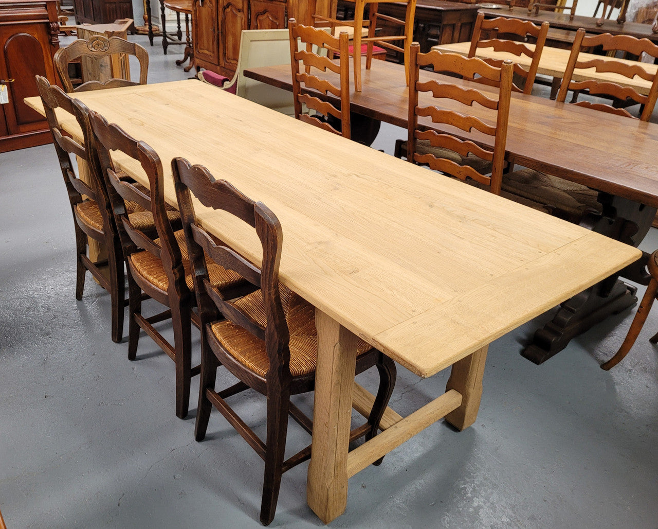 French raw Oak stretcher based refectory table. Features raw wood that could be used as is for a distressed look, or finished and waxed for a more refined look. Sourced from France and in good original condition.