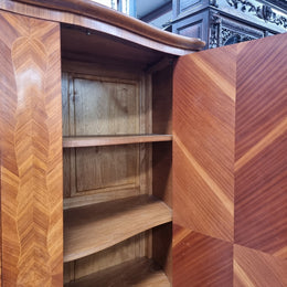 Charming French Louis XV Style Marquetry Inlaid Two Door Armoire. Features three adjustable shelves and ormolu trim. It has been sourced from France and is in good original condition.