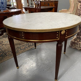 Stunning Antique French Louis XVI Style Mahogany & marble top round table. It has beautiful ormolu mounts and is in restored condition. Could be used as a dining table or as a center table.
